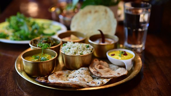 Closeup shot of an Indian tasty food called "Marwari Veg Thali" on the wooden table Food Image